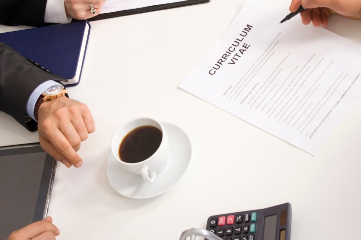 Colloquio di lavoro. Sul tavolo curriculum vitae e tazza di caffè